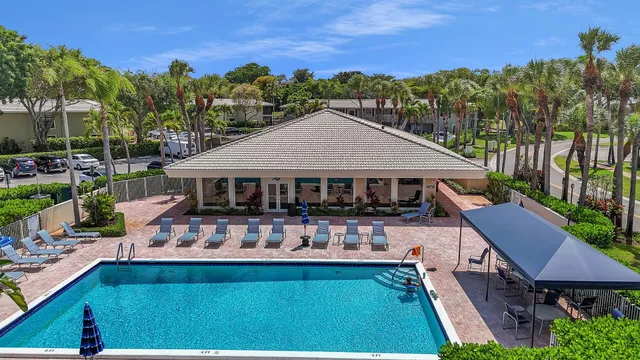 a aerial view of a house with swimming pool garden view and trees