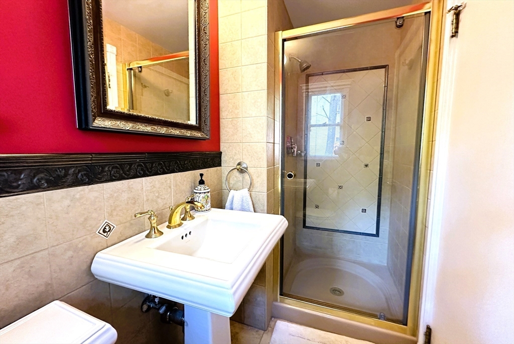 31 Sumner Road Brookline, MA 02445 - Photo 11 of 26 a bathroom with a sink and a mirror
