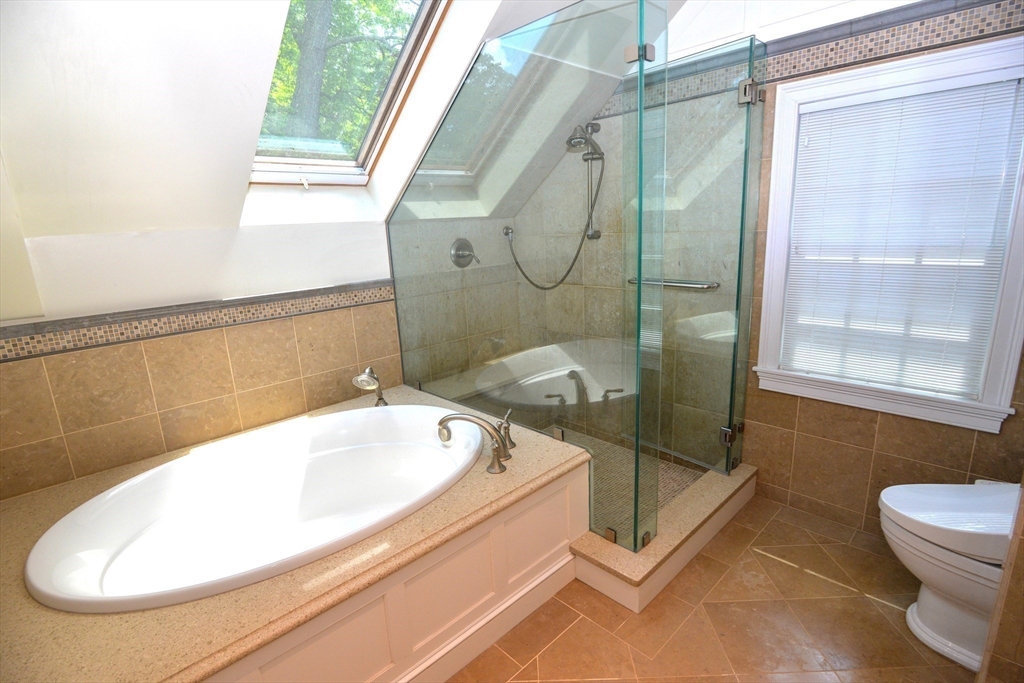 31 Sumner Road Brookline, MA 02445 - Photo 14 of 26 a bathroom with a tub a toilet and a shower