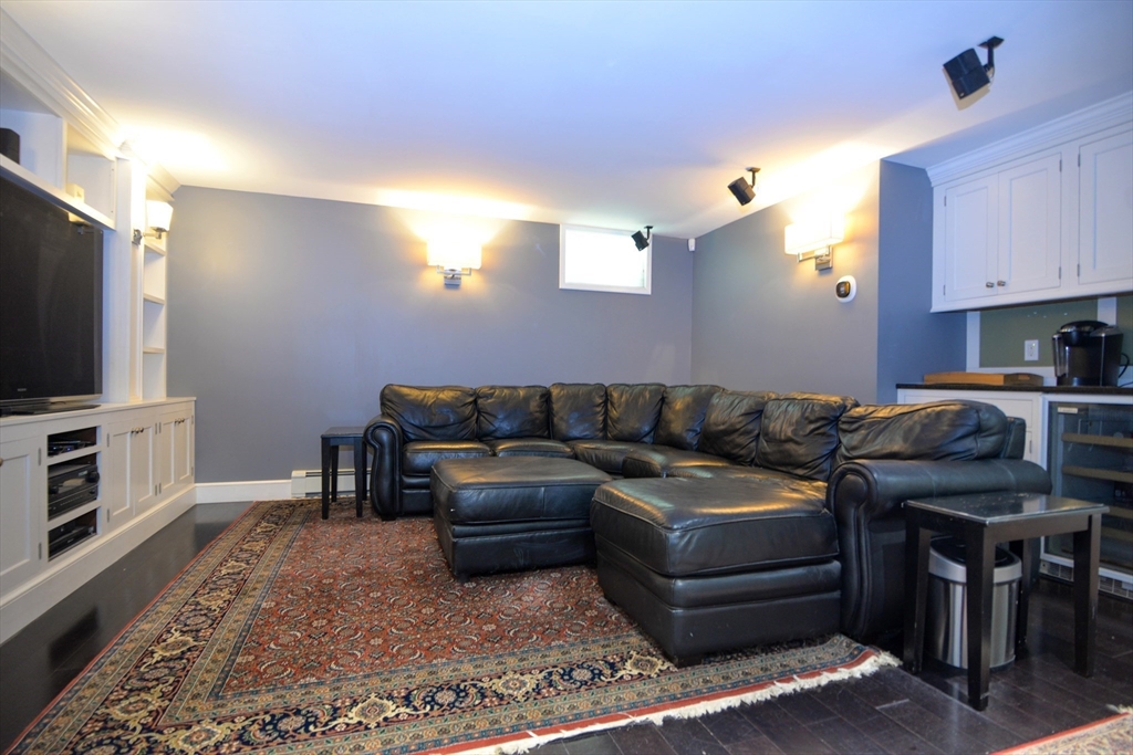 31 Sumner Road Brookline, MA 02445 - Photo 18 of 26 a living room with furniture a flat screen tv and kitchen view