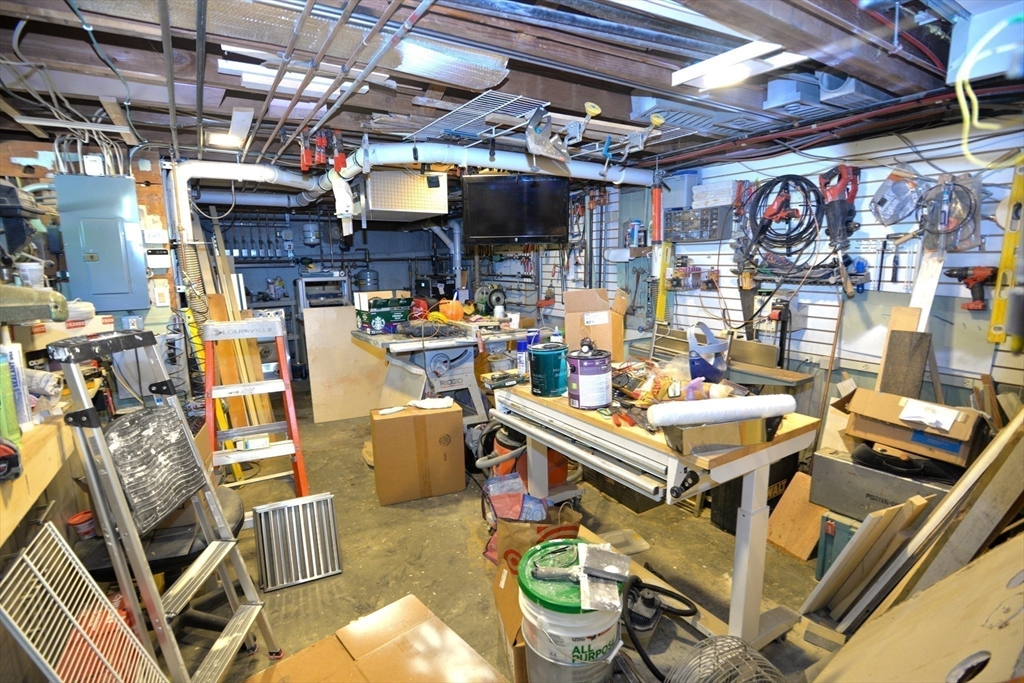 31 Sumner Road Brookline, MA 02445 - Photo 20 of 26 a view of a storage room with water heater and racks