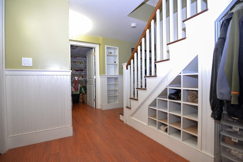 31 Sumner Road Brookline, MA 02445 - Photo 21 of 26 a view of front door with wooden floor and stairs