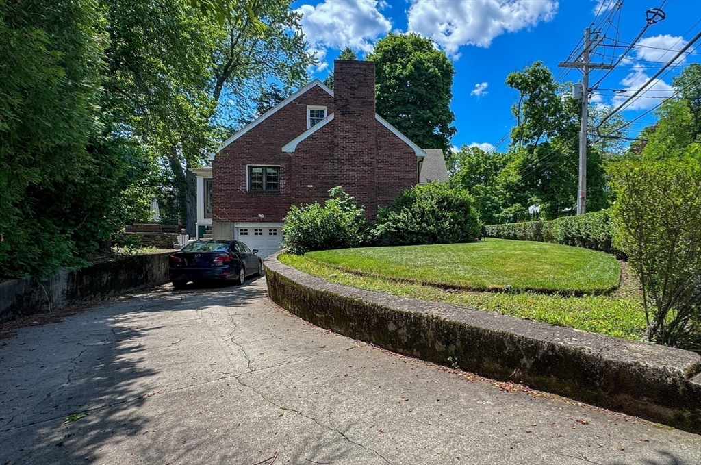 31 Sumner Road Brookline, MA 02445 - Photo 24 of 26 a view of a house with a yard and large trees