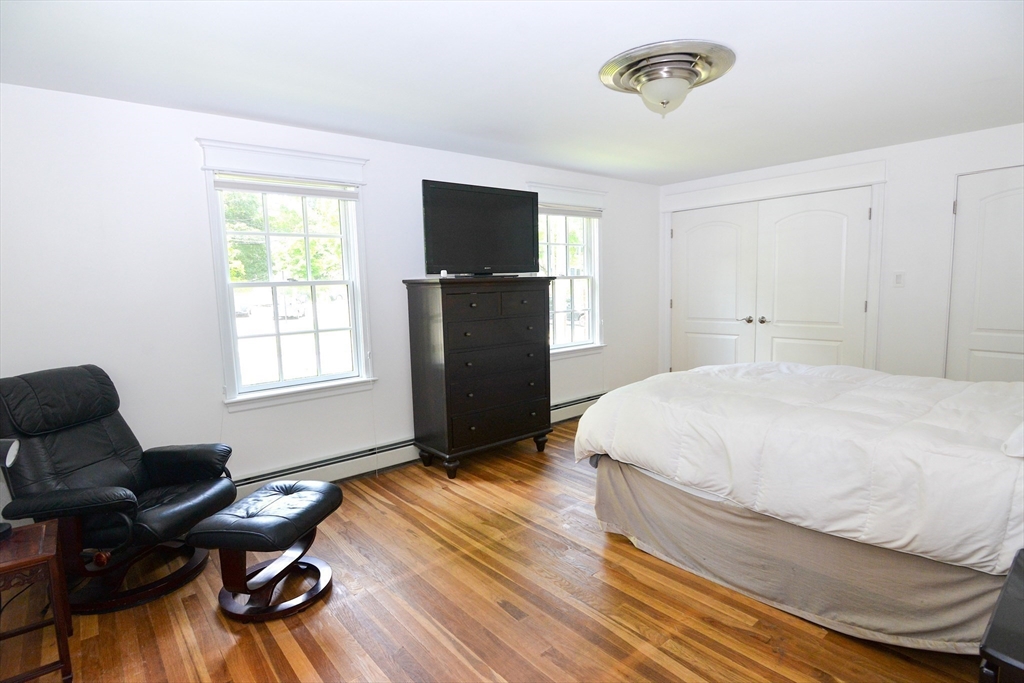 31 Sumner Road Brookline, MA 02445 - Photo 9 of 26 a bedroom with a bed and wooden floor