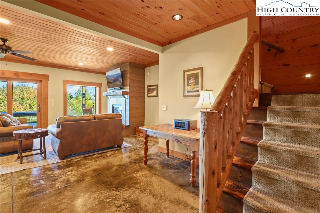 584 Grey Fox Ridge Road Banner Elk, NC 28604 - Photo 23 of 50 a view of a livingroom with furniture staircase and windows