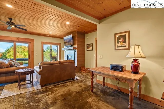 a view of a patio with table and chairs potted plants and a palm tree