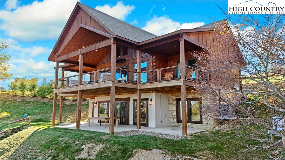 584 Grey Fox Ridge Road Banner Elk, NC 28604 - Photo 4 of 50 a view of a house with brick walls and a yard with plants
