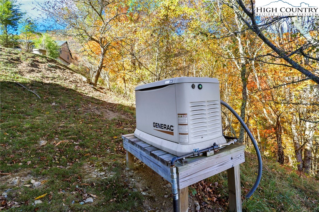 584 Grey Fox Ridge Road Banner Elk, NC 28604 - Photo 48 of 50 a view of a wooden deck with large trees