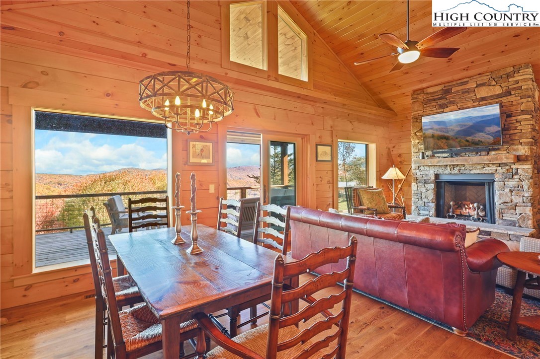 584 Grey Fox Ridge Road Banner Elk, NC 28604 - Photo 7 of 50 a view of a dining room with furniture a chandelier and wooden floor