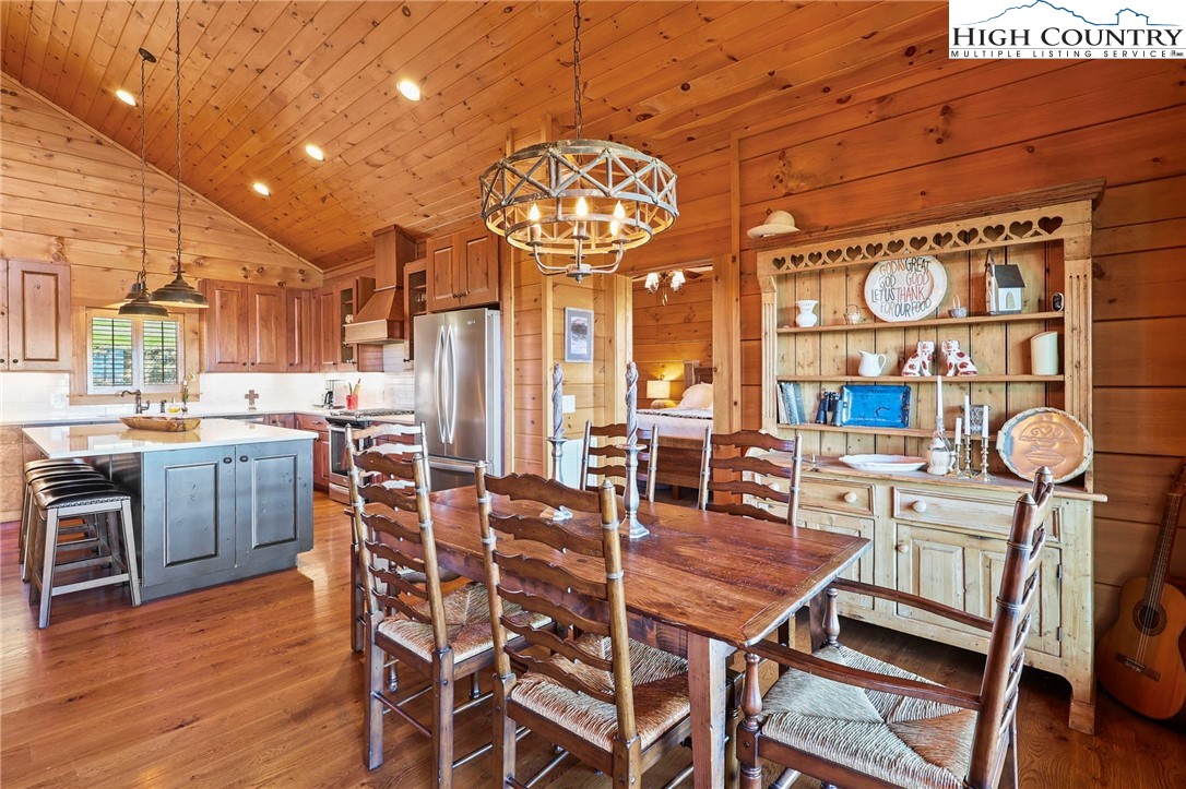 584 Grey Fox Ridge Road Banner Elk, NC 28604 - Photo 9 of 50 a view of a dining room with furniture wooden floor and chandelier