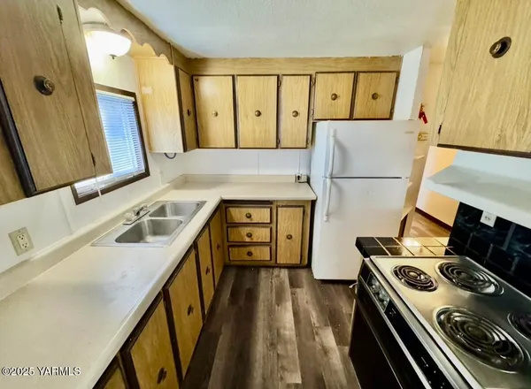 a view of a kitchen with a stove top oven