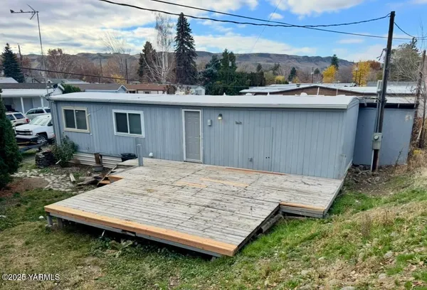 a view of a backyard with a sink and wooden fence