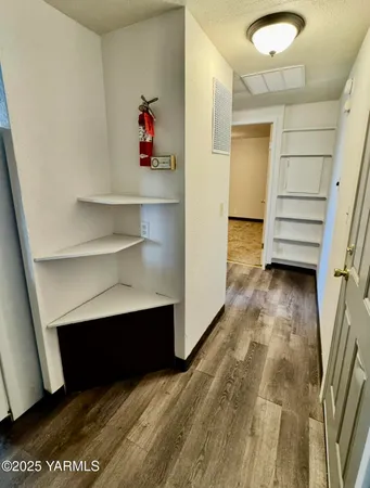 a view of a room with wooden floor and cabinet