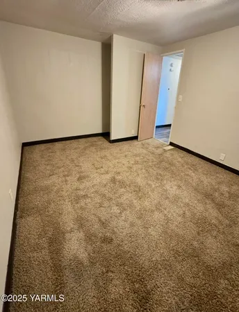 a view of a hallway with wooden floor and furniture