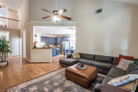 a living room with furniture and a chandelier
