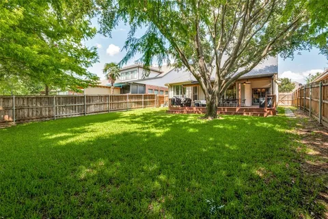 a backyard of a house with table and chairs