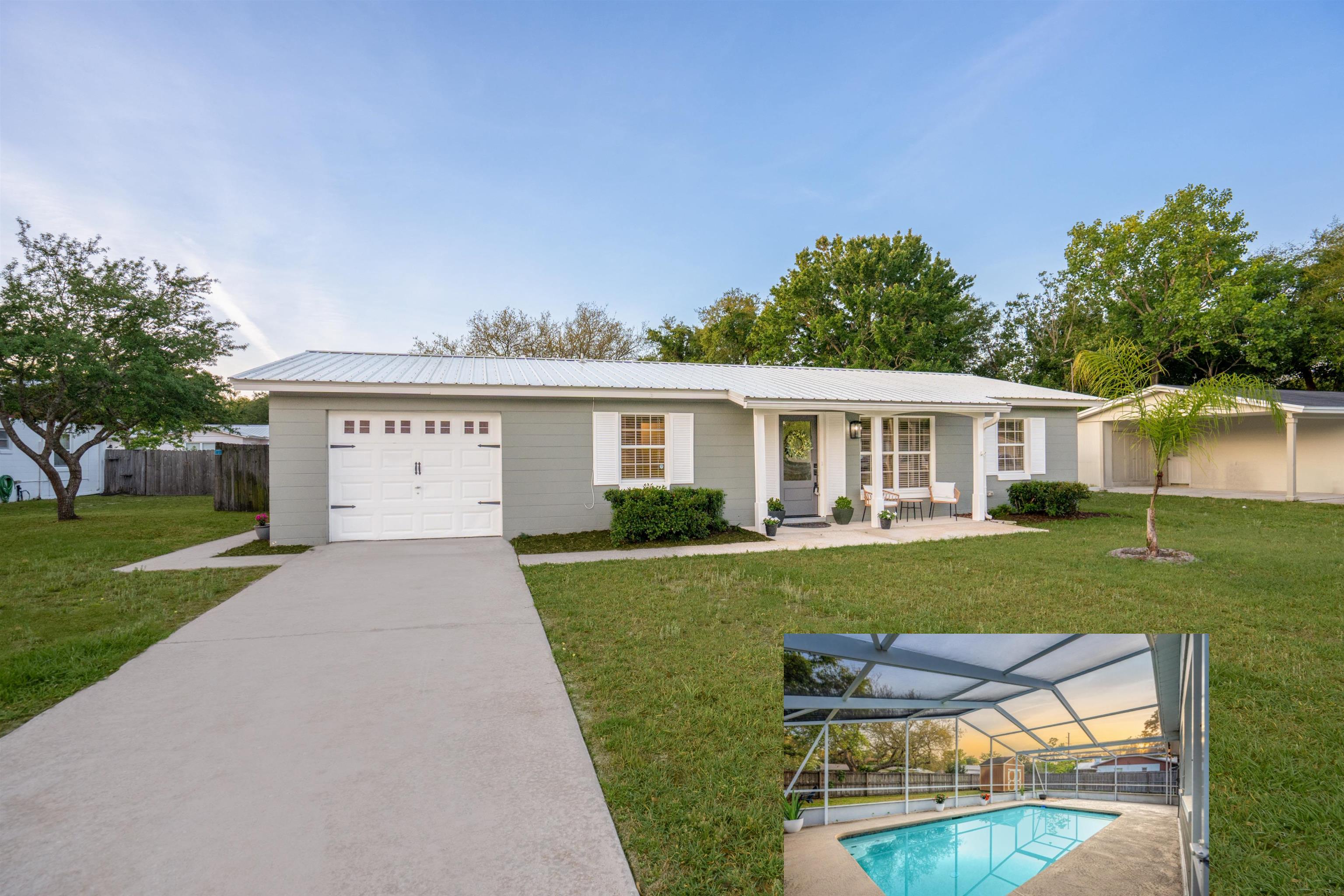 Ranch-style home with a metal roof, glass enclosure, a garage, and concrete driveway