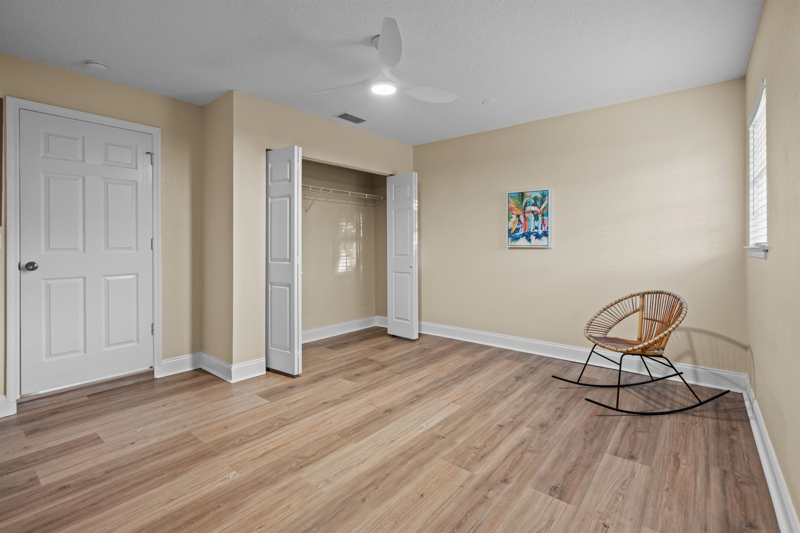 285 Trillo Street St. Augustine, FL 32086 - Photo 11 of 48 Unfurnished bedroom featuring a closet, a ceiling fan, and light wood finished floors