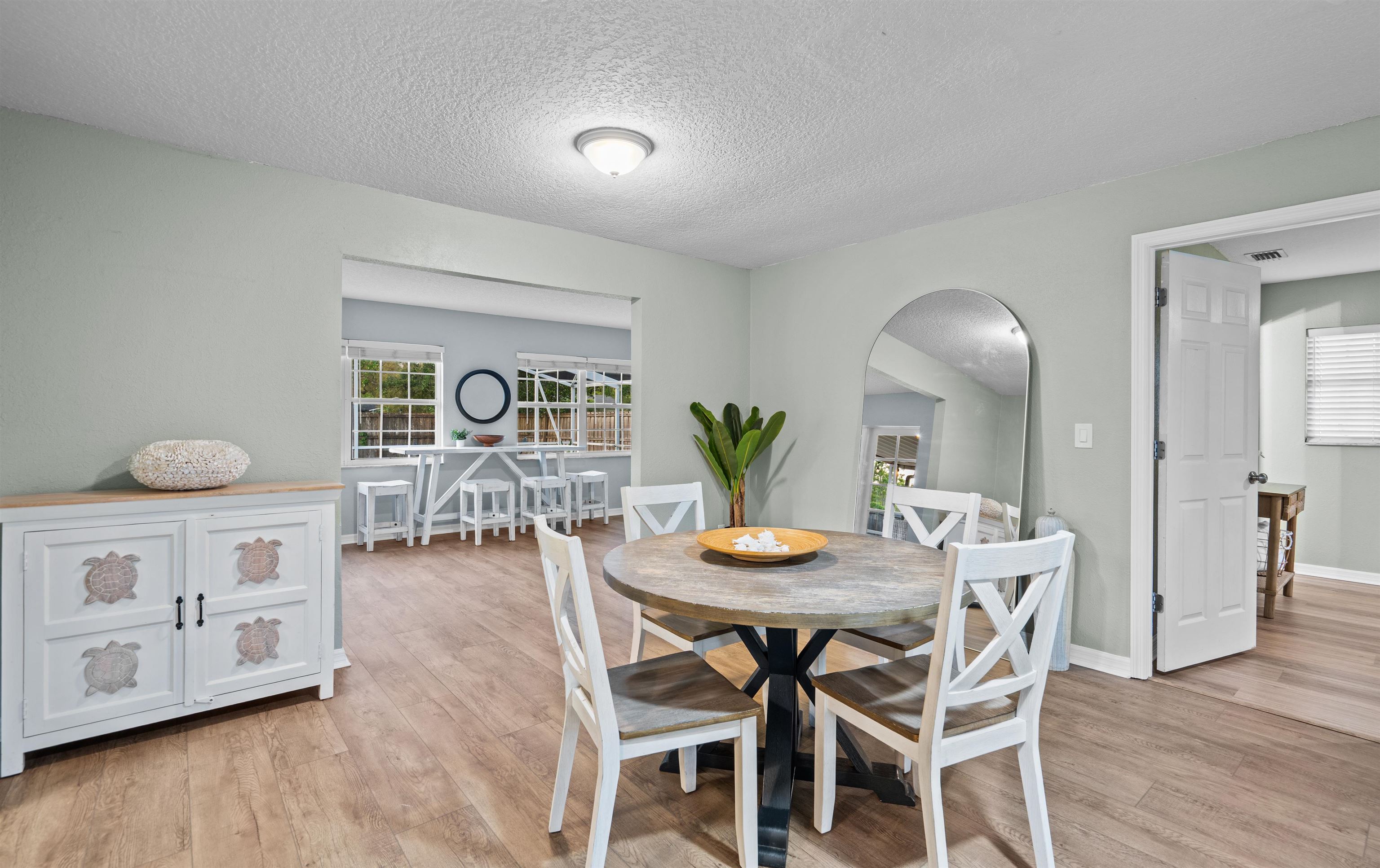 285 Trillo Street St. Augustine, FL 32086 - Photo 15 of 48 Dining space featuring arched walkways, a textured ceiling, and light wood finished floors