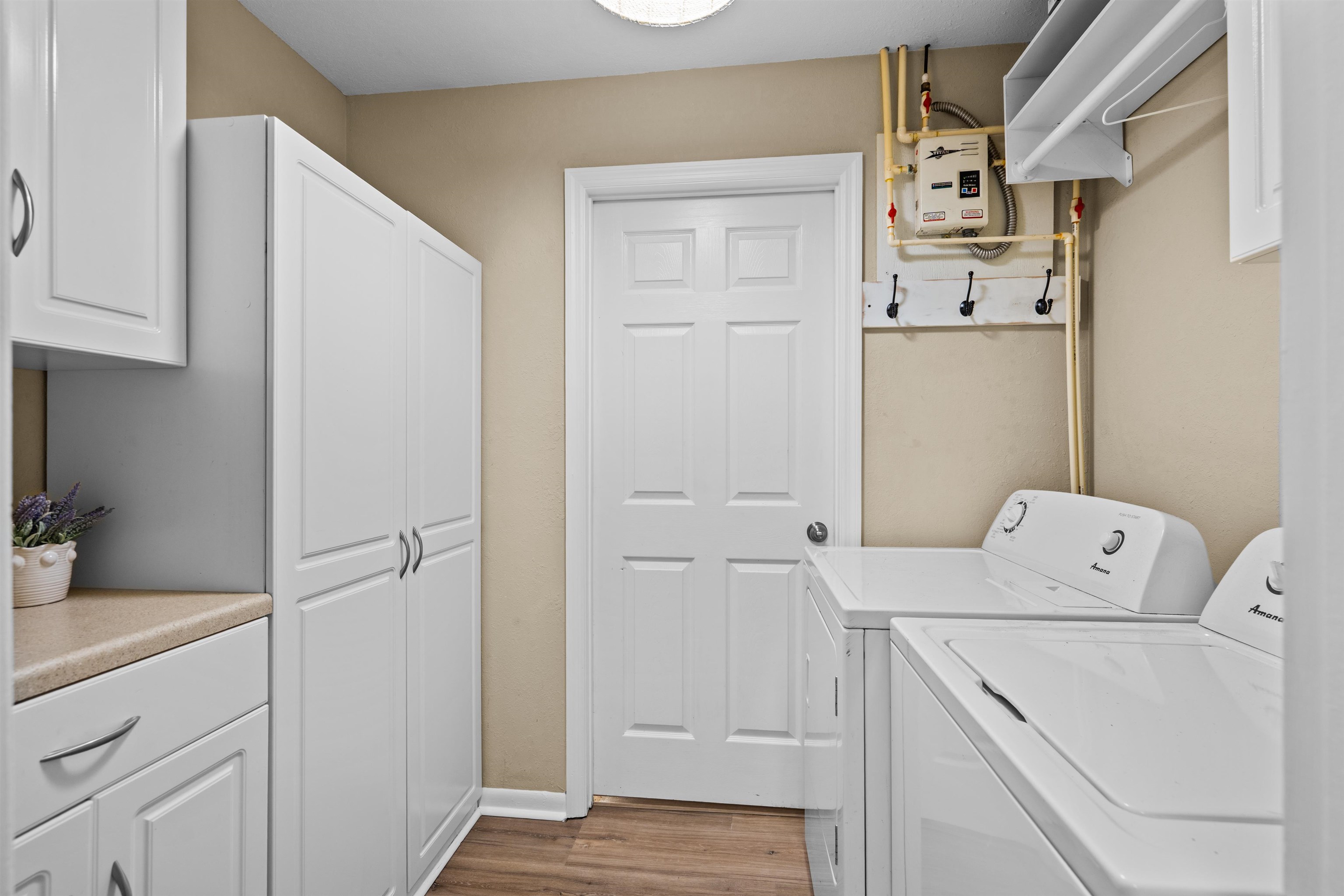 285 Trillo Street St. Augustine, FL 32086 - Photo 19 of 48 Laundry room with independent washer and dryer, dark wood-type flooring, and cabinet space