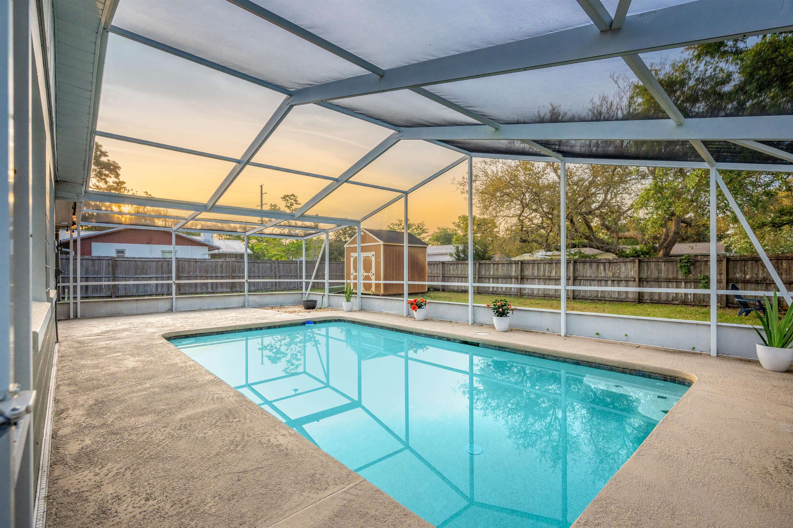 285 Trillo Street St. Augustine, FL 32086 - Photo 24 of 48 View of swimming pool with a lanai, a fenced backyard, a sunroom, and a storage shed