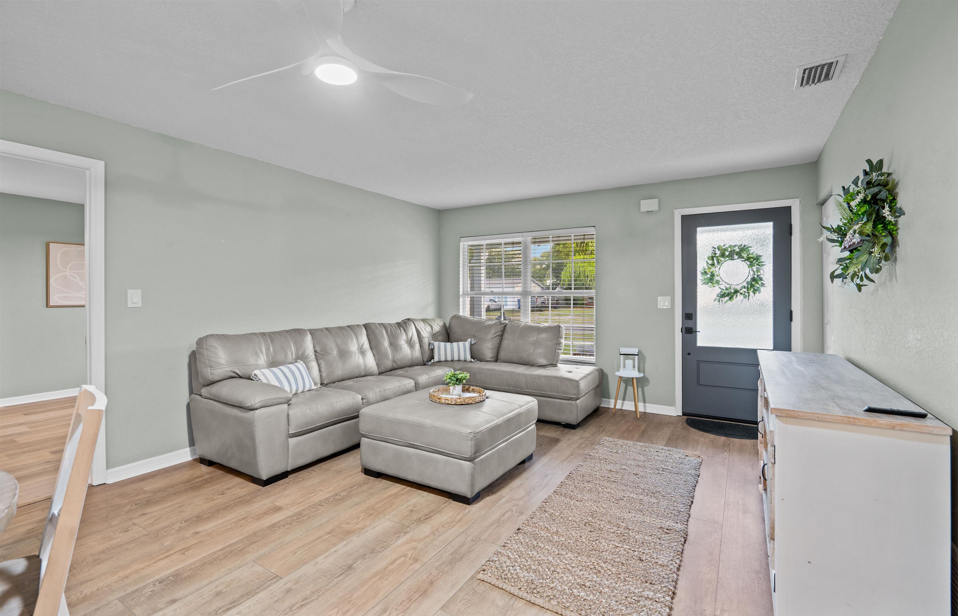 285 Trillo Street St. Augustine, FL 32086 - Photo 7 of 48 Living area with light wood-type flooring, a ceiling fan, and a textured ceiling