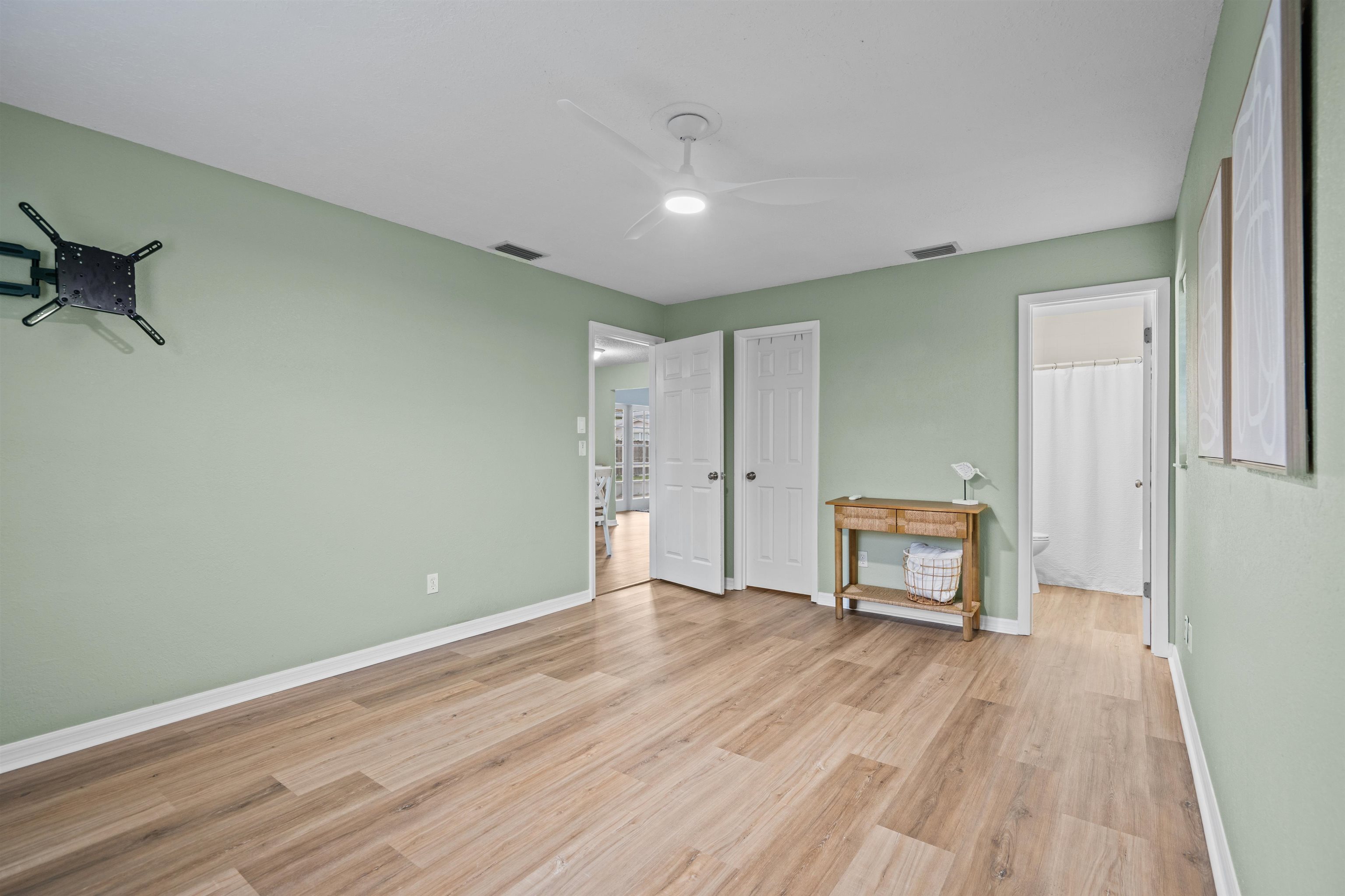 285 Trillo Street St. Augustine, FL 32086 - Photo 9 of 48 Unfurnished bedroom featuring light wood-type flooring, ensuite bathroom, and a ceiling fan