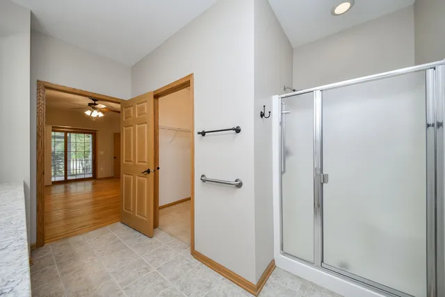 a view of a bathroom with tub and shower