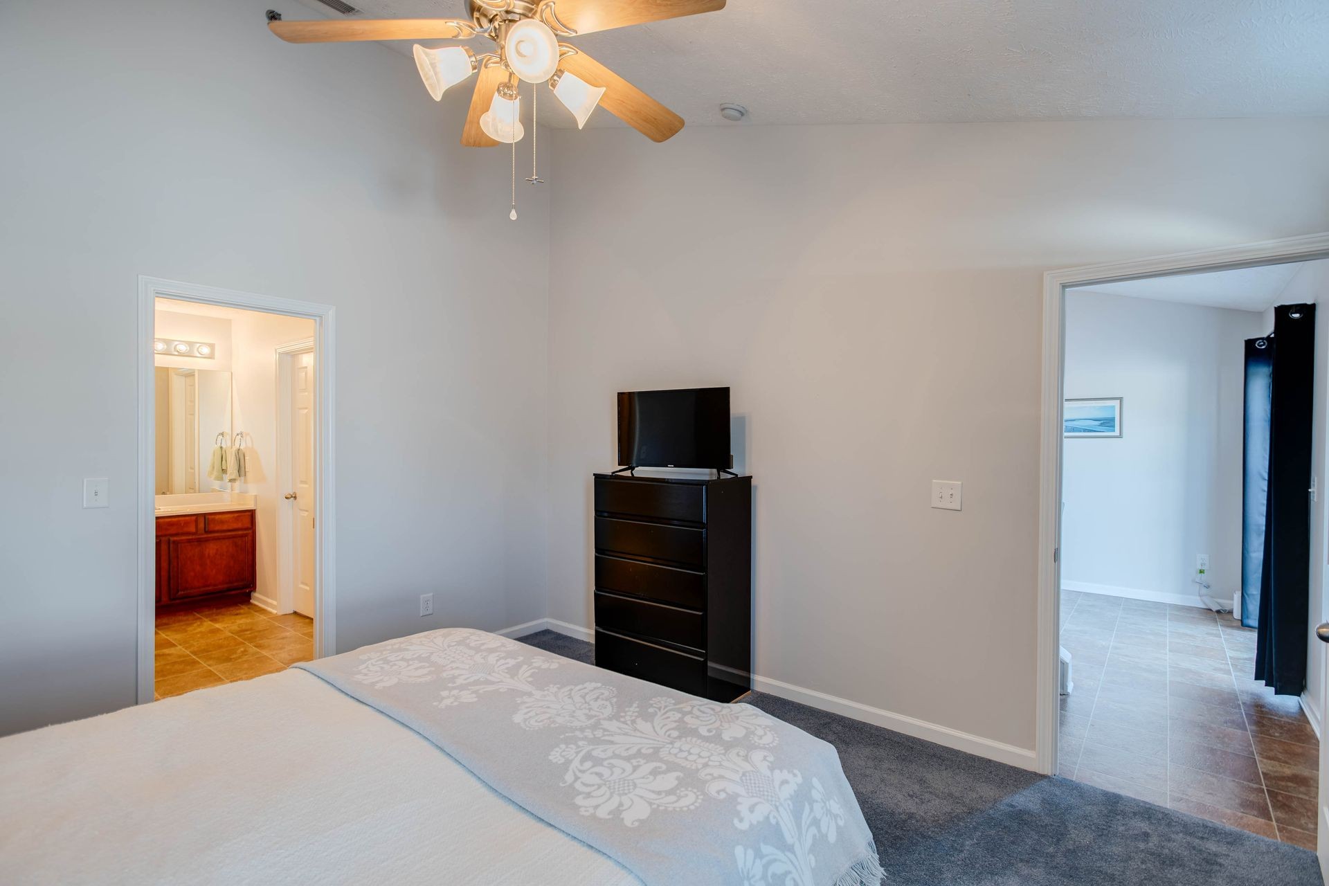 3057 Soaring Eagle Way Spring Hill, TN 37174 - Photo 12 of 32 a bedroom with a bed and a chandelier