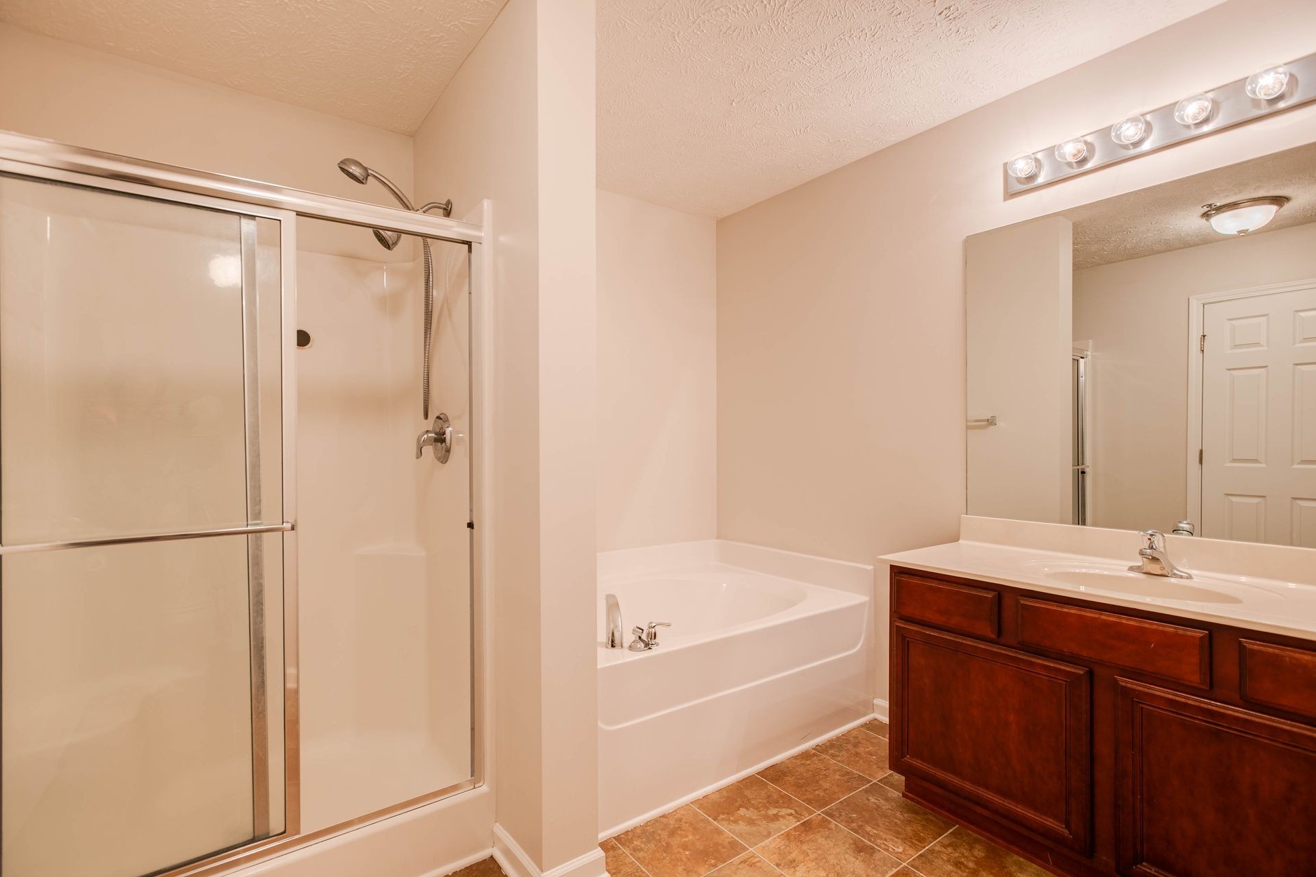 3057 Soaring Eagle Way Spring Hill, TN 37174 - Photo 15 of 32 a bathroom with a tub shower sink and mirror