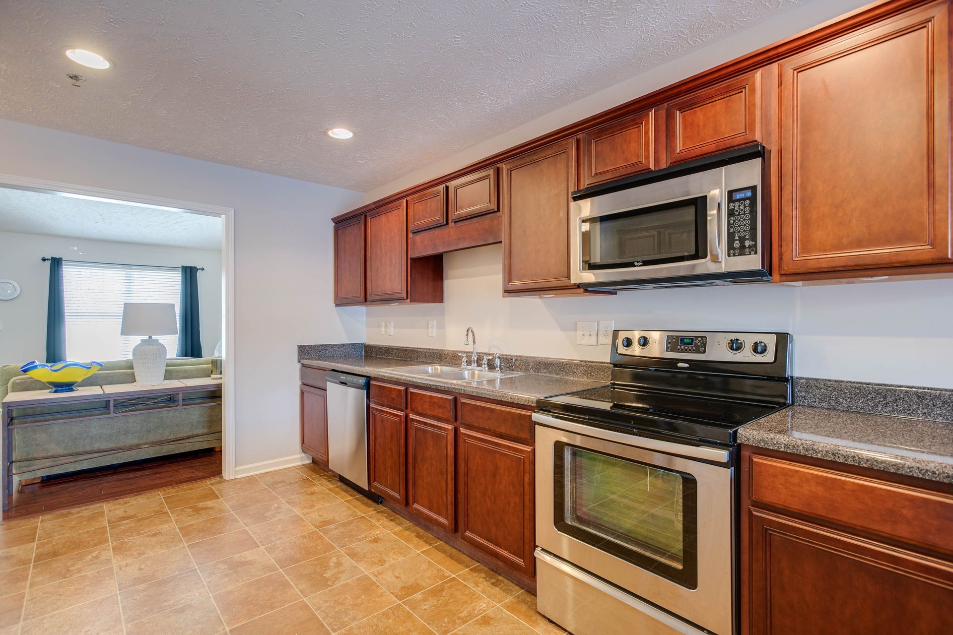 3057 Soaring Eagle Way Spring Hill, TN 37174 - Photo 7 of 32 a kitchen with stainless steel appliances granite countertop a stove and a microwave