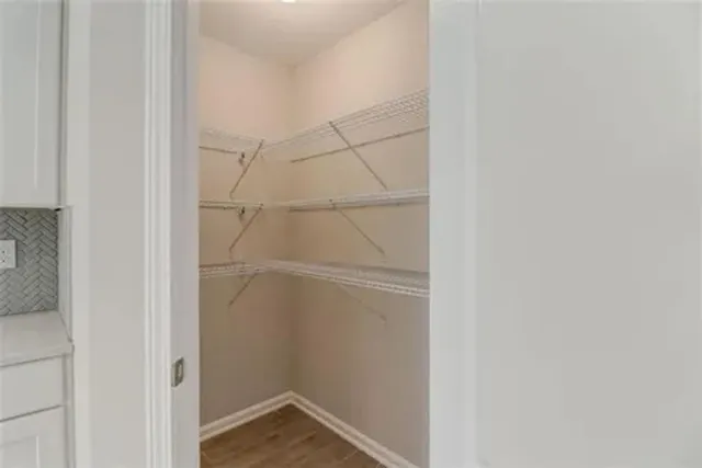 a view of an empty walk in closet with empty racks