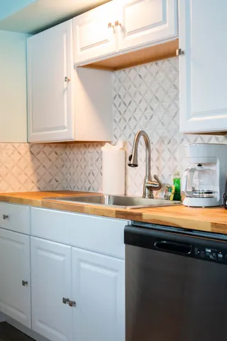 a close view of sink and cabinets