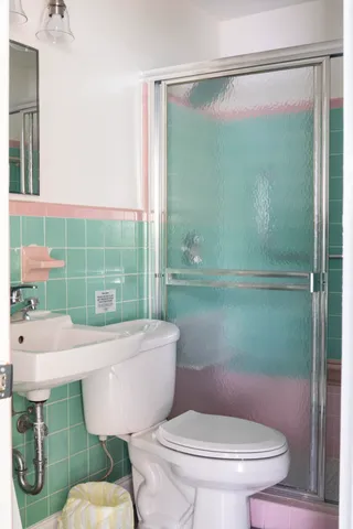 a bathroom with a sink toilet and shower