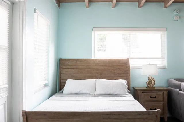 a bedroom with a bed and window