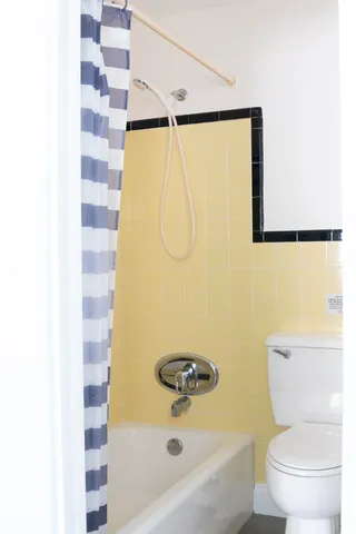 a bathroom with a shower and a toilet