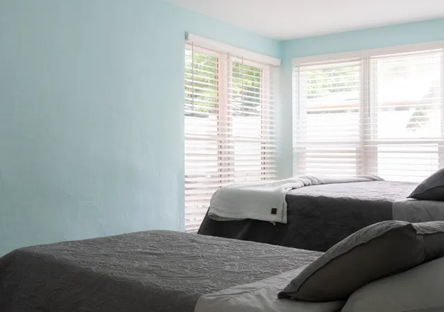 a bedroom with a bed and a couch next to a window