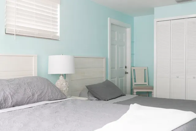 a bedroom with a bed and a night stand