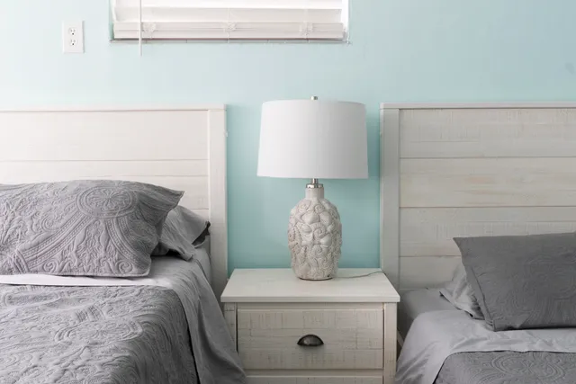 a bed sitting in a bedroom and lamp