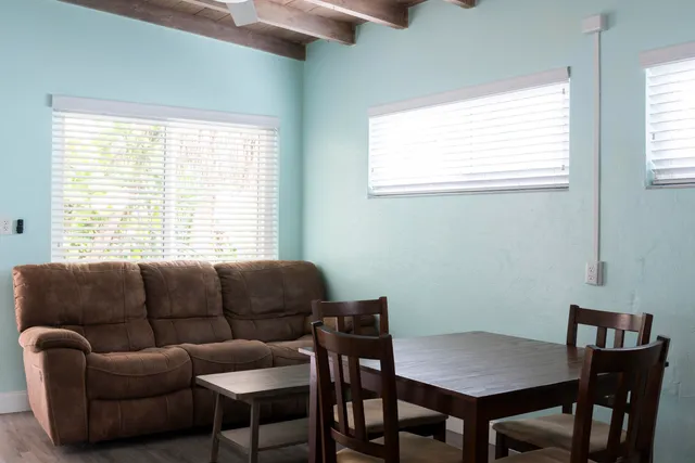 a view of a dining room with furniture and a window