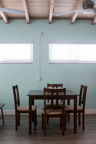 a view of a dining room with furniture and window
