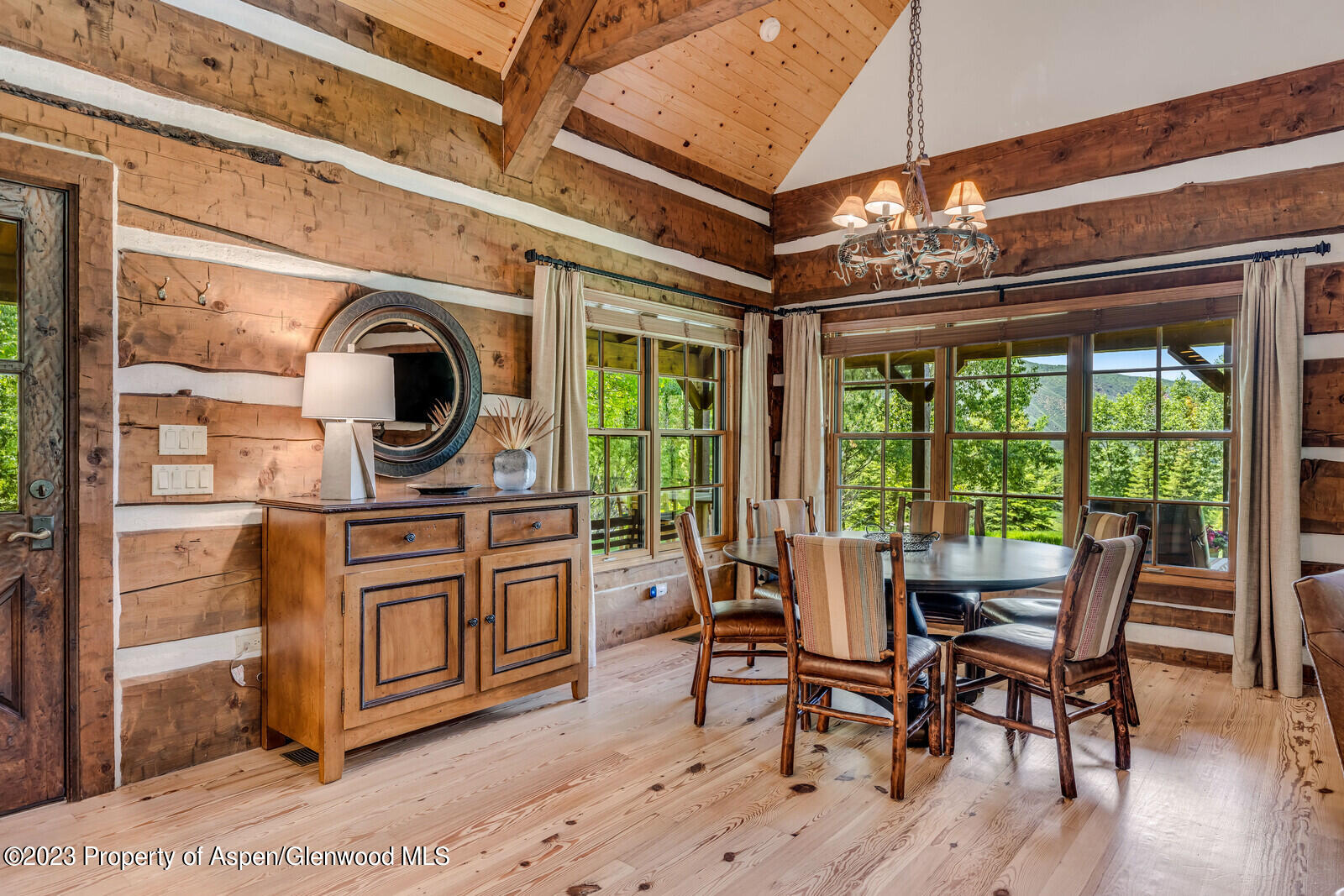 6 A Arbaney Ranch Road Basalt, CO 81621 - Photo 16 of 44 a dining room with wooden floor a chandelier a glass table and chairs