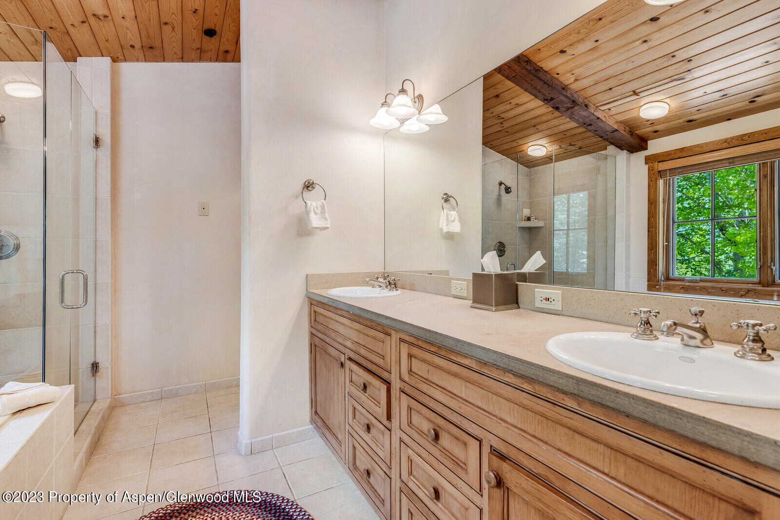 6 A Arbaney Ranch Road Basalt, CO 81621 - Photo 23 of 44 a spacious bathroom with a double vanity sink a mirror and a shower