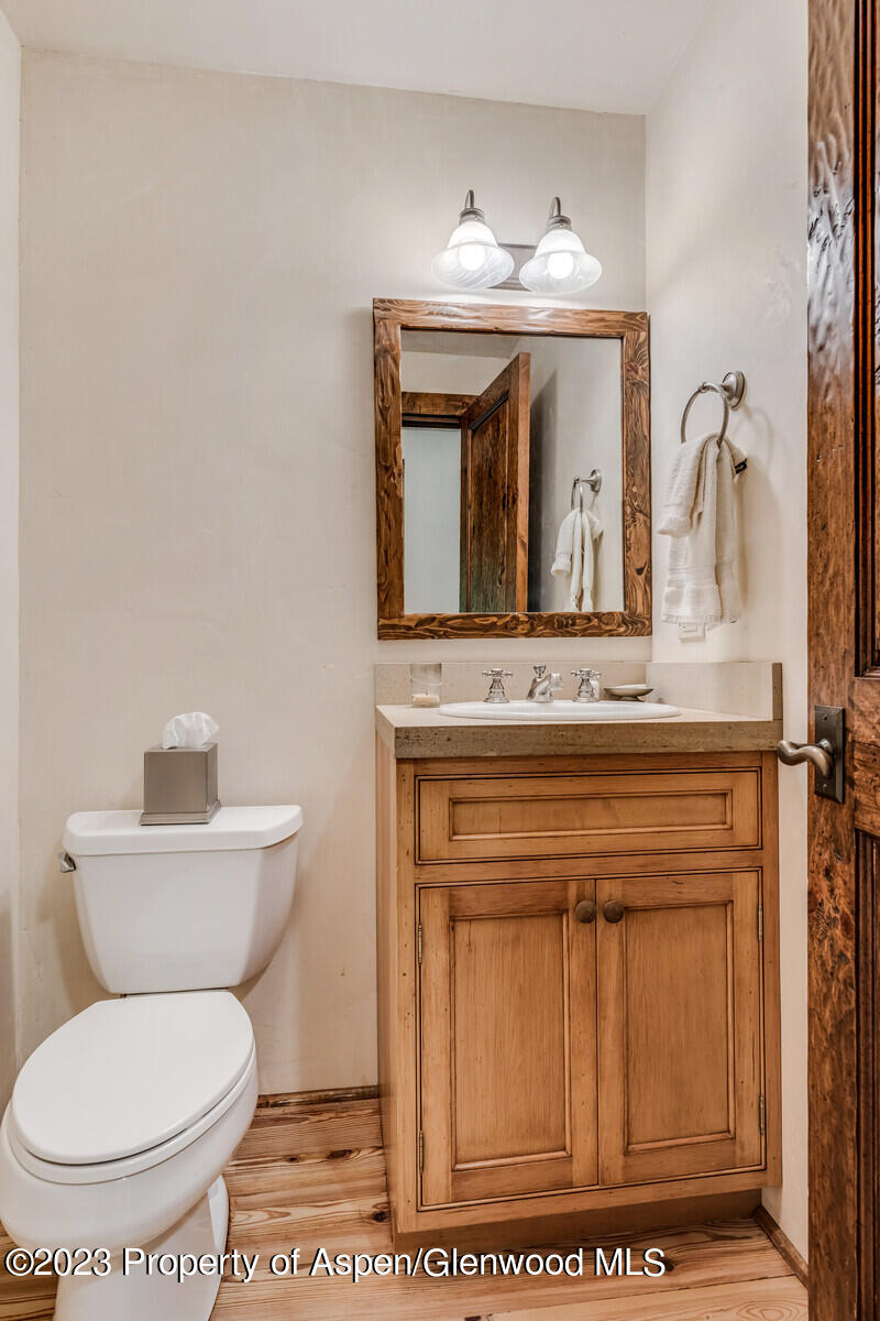 6 A Arbaney Ranch Road Basalt, CO 81621 - Photo 31 of 44 a bathroom with a toilet a sink and mirror