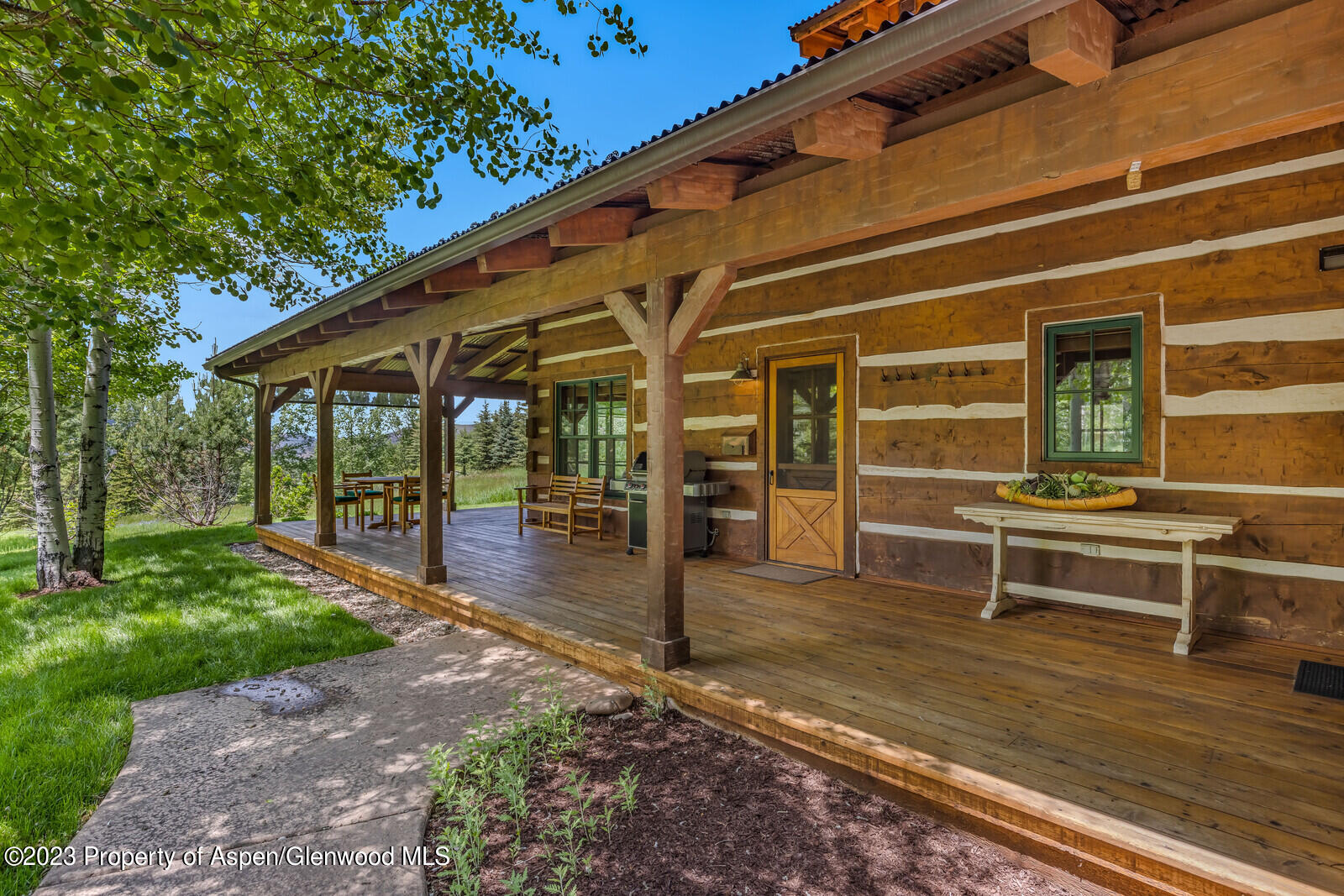 6 A Arbaney Ranch Road Basalt, CO 81621 - Photo 33 of 44 a view of a patio with table and chairs with wooden floor and fence