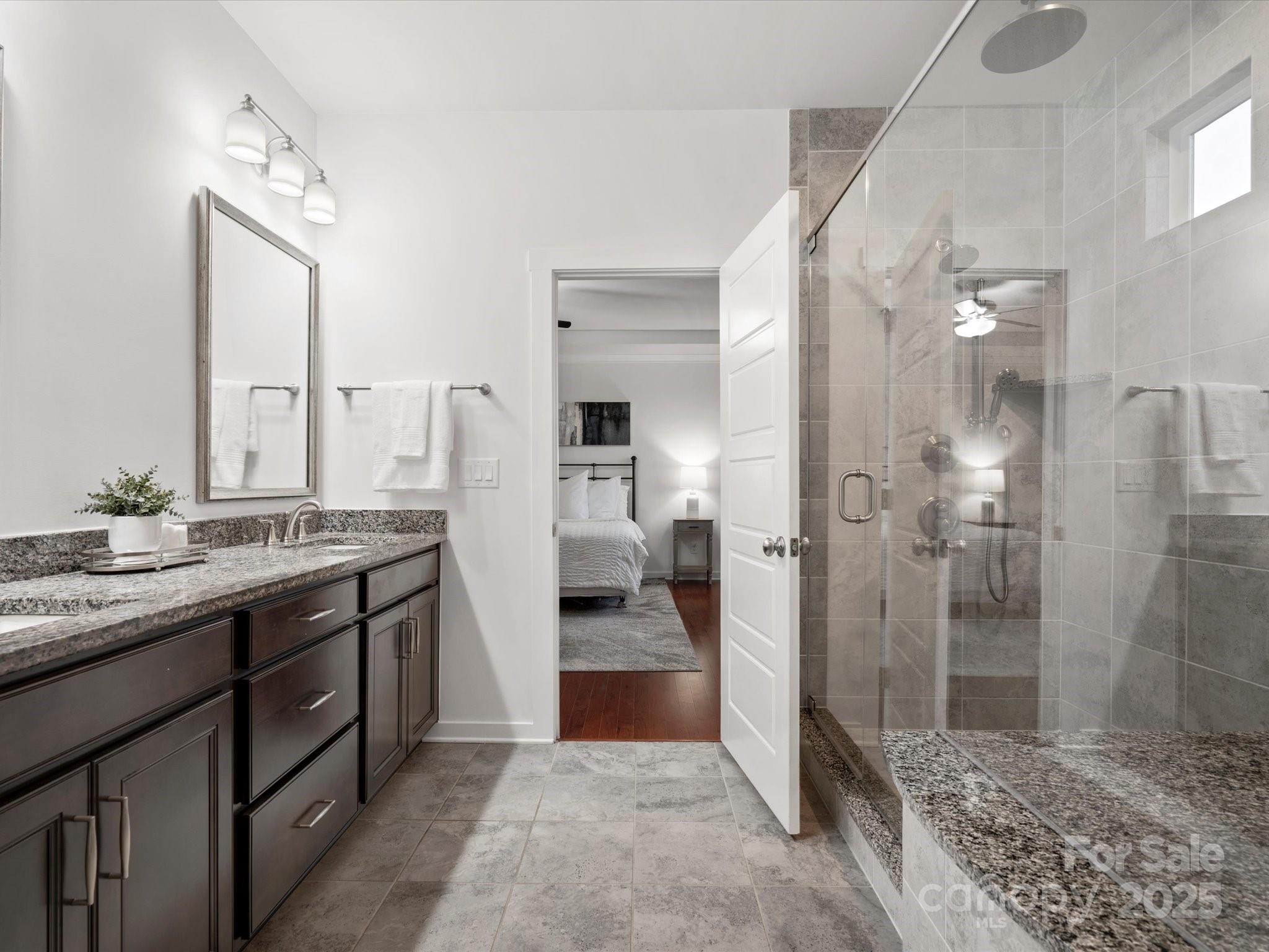 523 Rock Skip Way Fort Mill, SC 29708 - Photo 25 of 48 a bathroom with a double vanity sink a toilet and shower