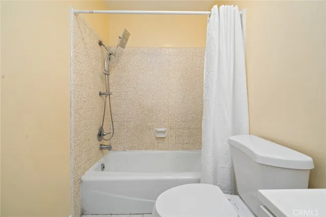 a bathroom with a toilet and a bathtub