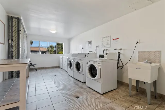 a utility room with cabinets dryer and washer