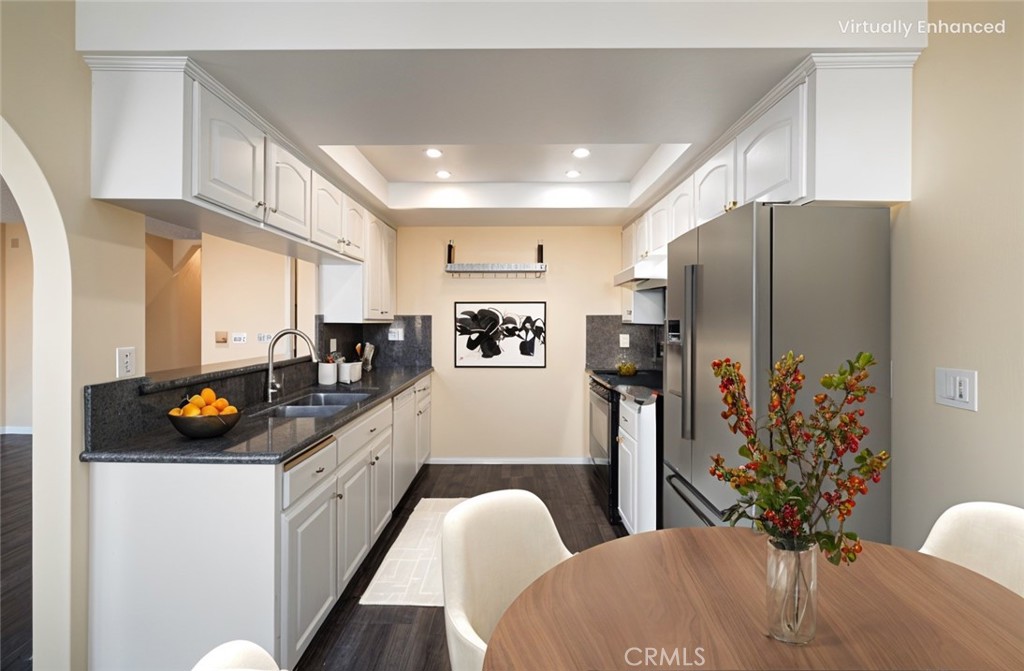 1311 South Grand Avenue, Unit 5 San Pedro, CA 90731 - Photo 4 of 20 a kitchen with stainless steel appliances a refrigerator sink and cabinets