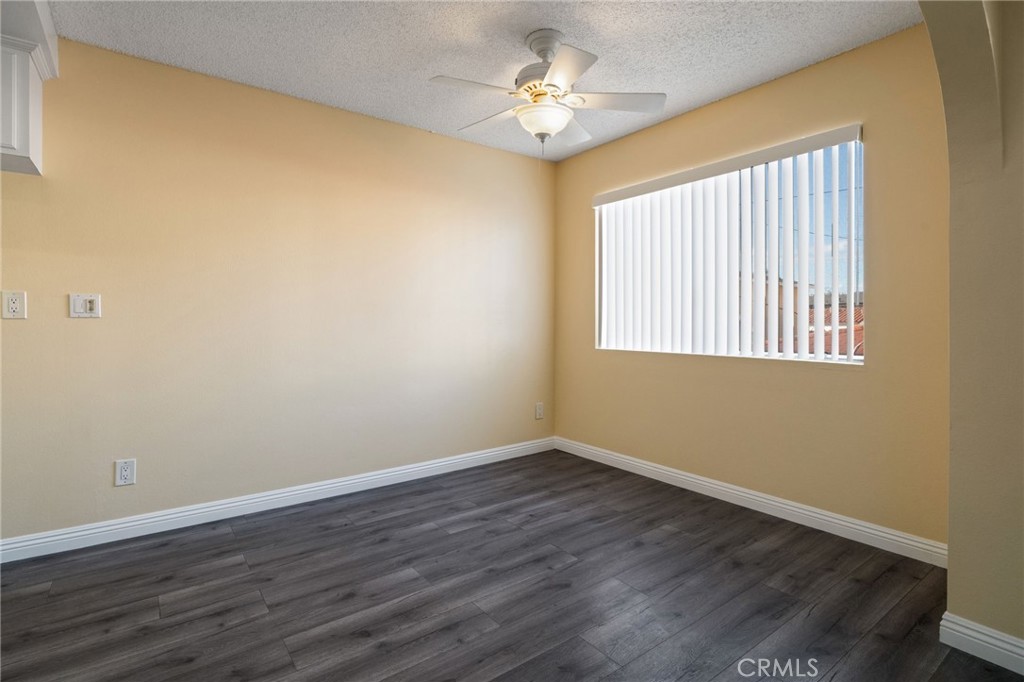 1311 South Grand Avenue, Unit 5 San Pedro, CA 90731 - Photo 8 of 20 a view of an empty room with wooden floor and a window